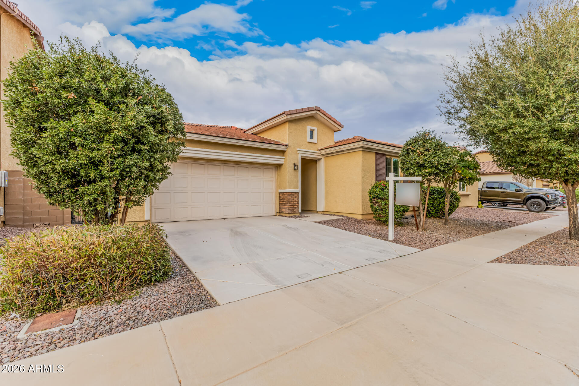 4228 West Coles Road Laveen, AZ 85339 - Photo 3 of 36 a view of a white house with a yard and potted plants