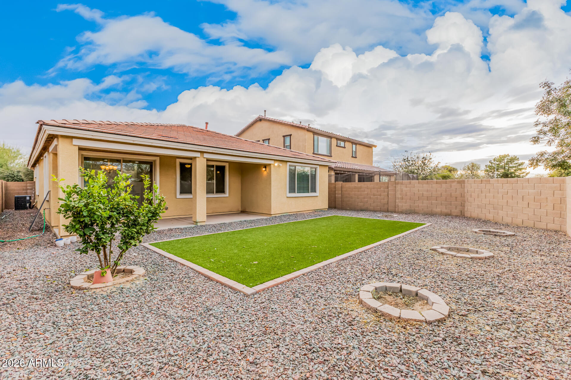 4228 West Coles Road Laveen, AZ 85339 - Photo 32 of 36 a front view of a house with a yard and garage