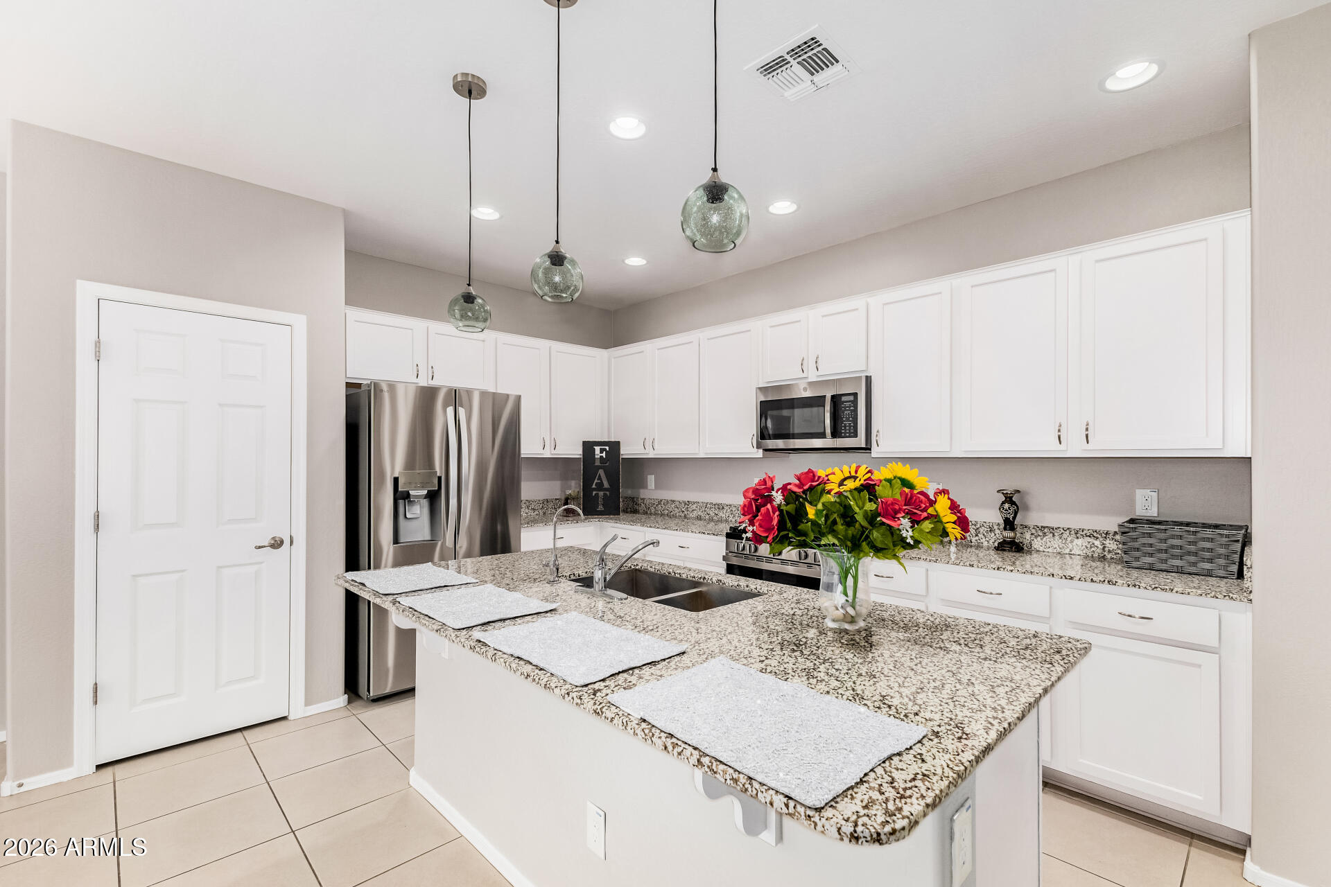 4228 West Coles Road Laveen, AZ 85339 - Photo 9 of 36 a kitchen that has a lot of cabinets and refrigerator