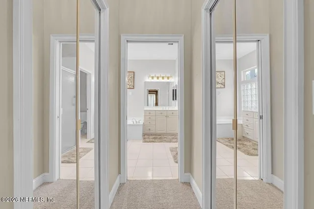 a bathroom with a tub sink and mirror