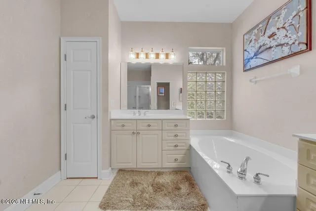 a spacious bathroom with a granite countertop sink mirror and a shower