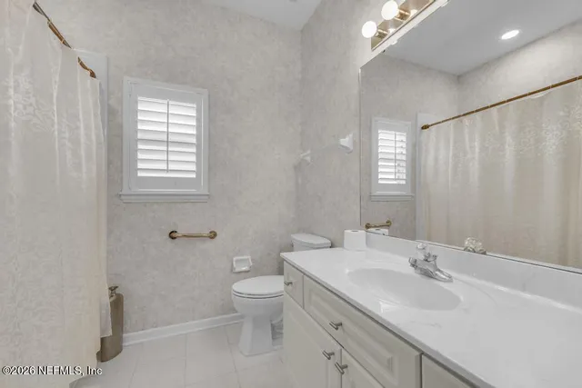 a bathroom with a toilet sink and shower