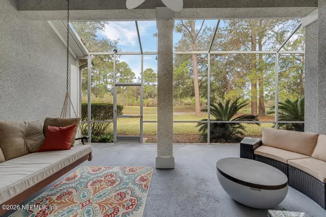 a lobby with furniture and large windows