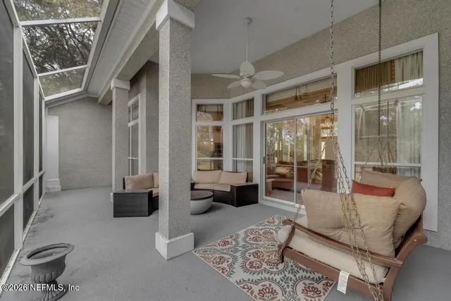 a living room with furniture and a floor to ceiling window