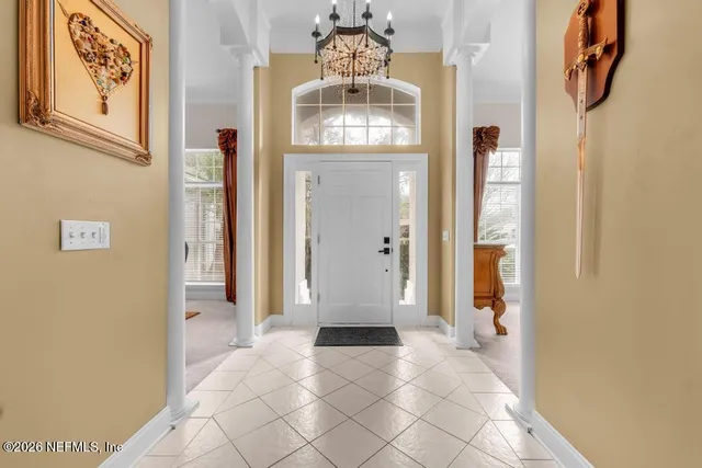 a view of a hallway with wooden floor and entryway