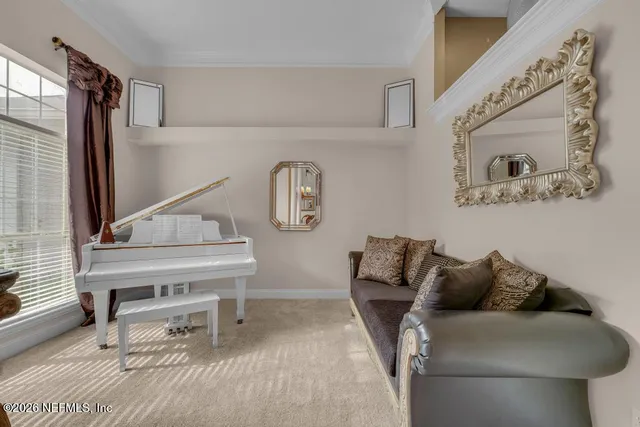 a living room with furniture and a piano