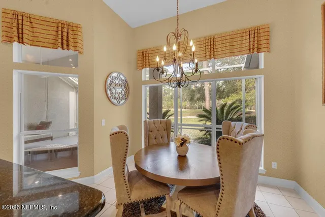 a view of a dining room with furniture and chandelier