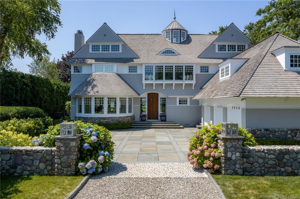a front view of a house with a garden