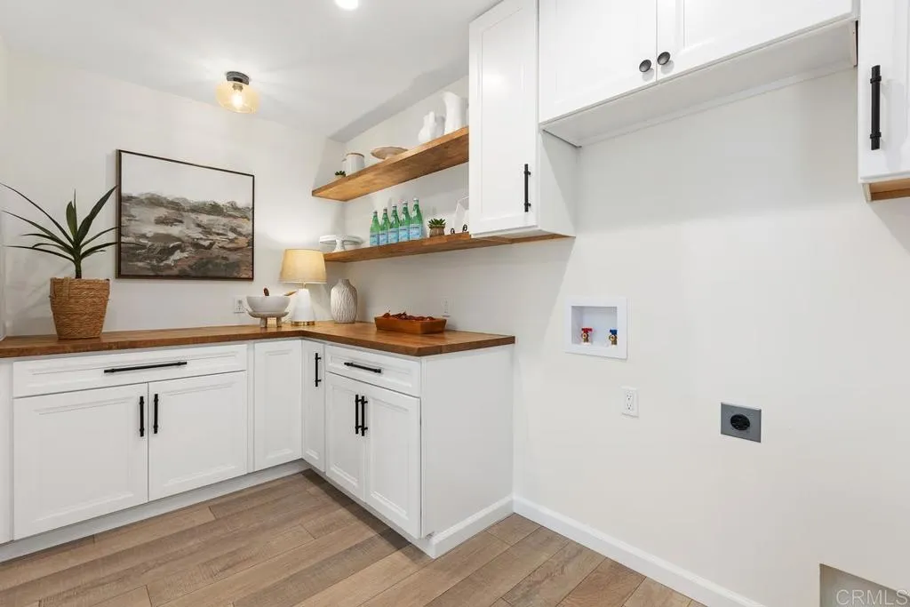 7144 Santa Rosa, Unit 86 Carlsbad, CA 92011 - Photo 11 of 41 a kitchen with granite countertop white cabinets and white appliances