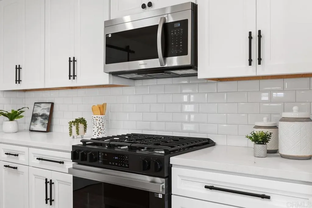 7144 Santa Rosa, Unit 86 Carlsbad, CA 92011 - Photo 12 of 41 a stove top oven sitting inside of a kitchen