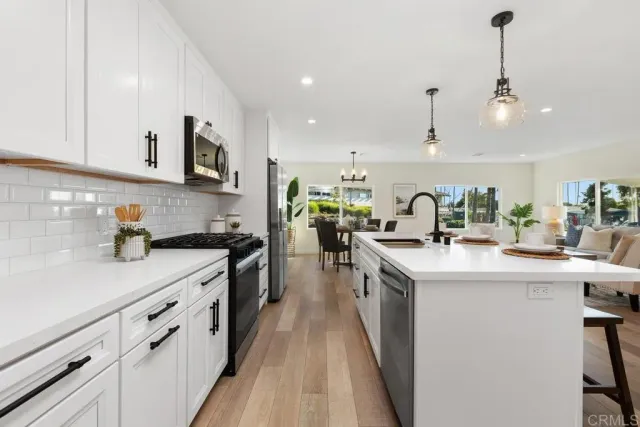 a kitchen with cabinets a sink and appliances