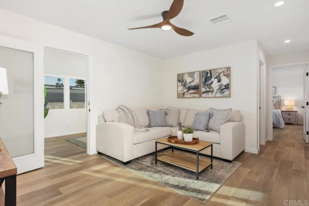 7144 Santa Rosa, Unit 86 Carlsbad, CA 92011 - Photo 16 of 41 a living room with furniture a ceiling fan and a rug