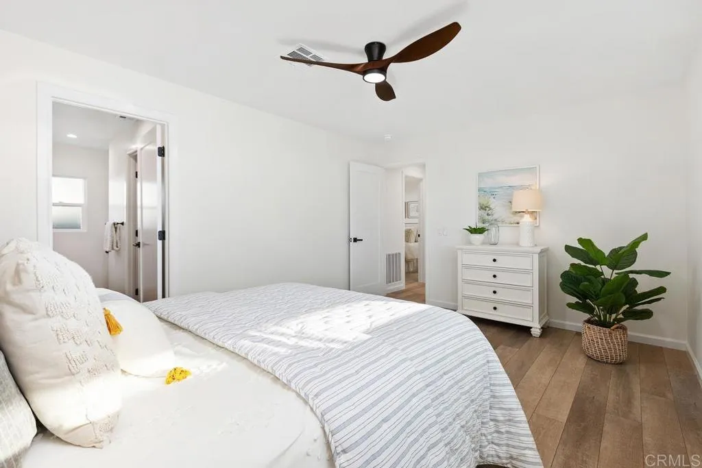 7144 Santa Rosa, Unit 86 Carlsbad, CA 92011 - Photo 22 of 41 a bedroom with a bed dresser and a living room