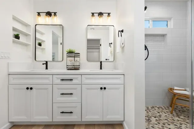 a bathroom with a sink vanity and mirror