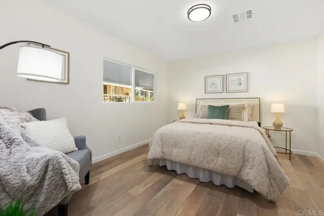 a bedroom with a bed and a lamp