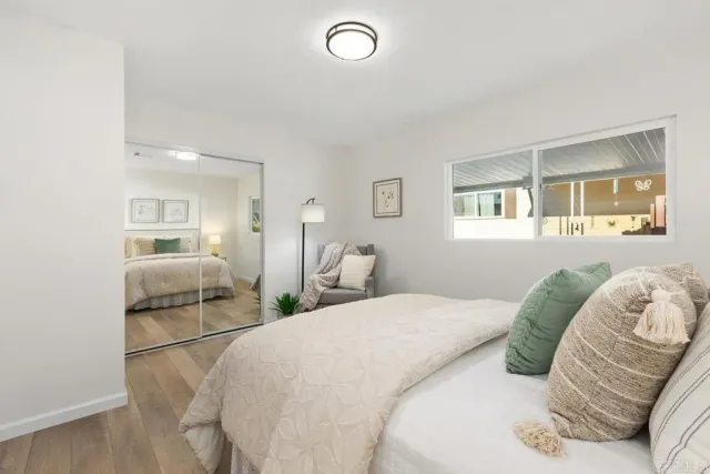 a bedroom with a bed and a large mirror