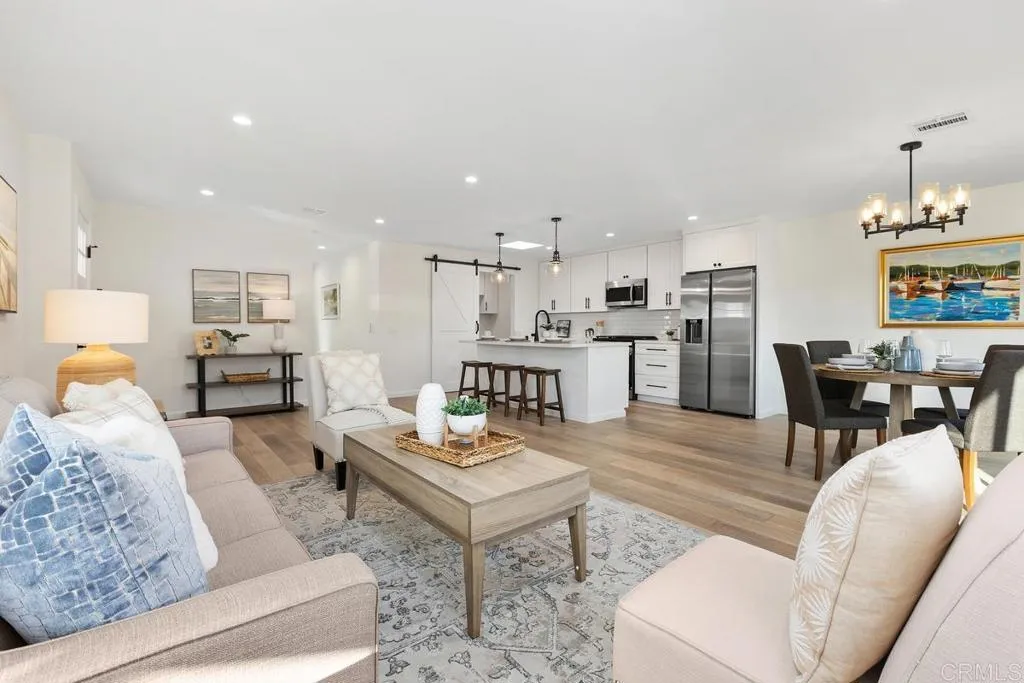 7144 Santa Rosa, Unit 86 Carlsbad, CA 92011 - Photo 6 of 41 a living room with furniture and kitchen view