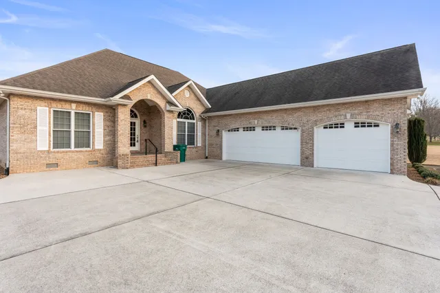 a view of empty room with wooden floor and fireplace