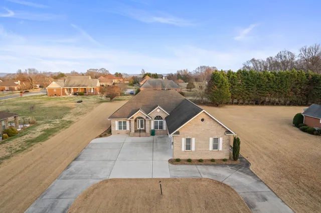 a view of a house with a yard and sitting area