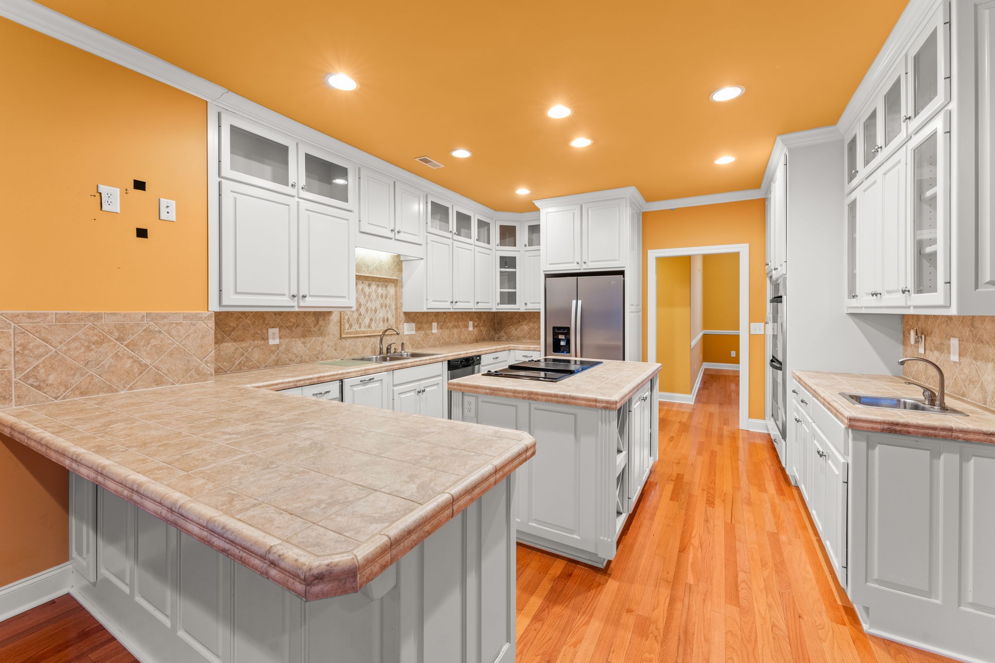 657 Pickney Road Winchester, TN 37398 - Photo 41 of 66 a kitchen with stainless steel appliances granite countertop a stove top oven a sink dishwasher and a refrigerator with wooden floor