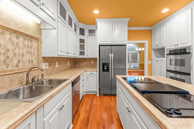 a view of cabinets and utility room with a window