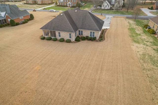 a front view of house with yard and car parked