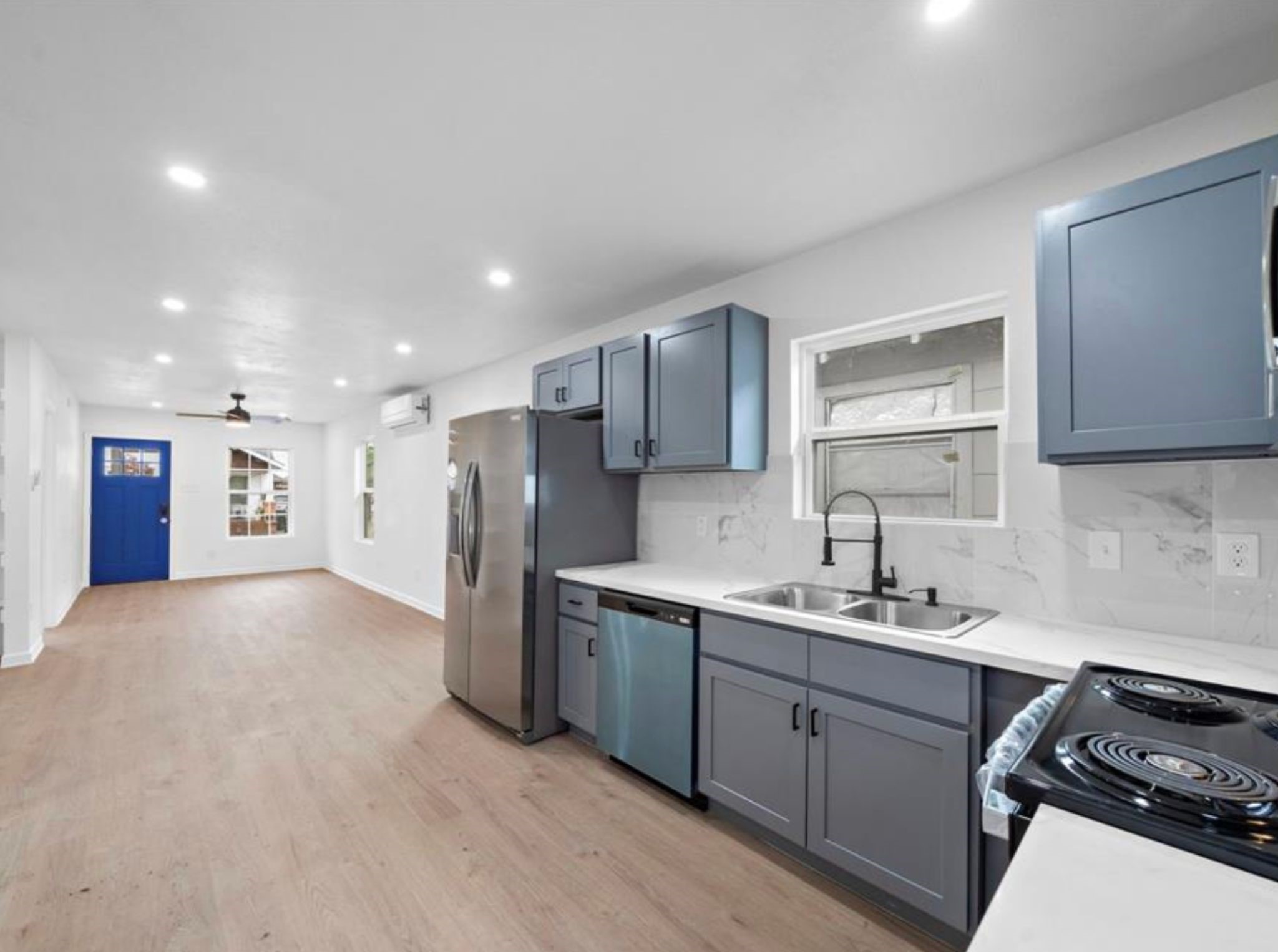 a kitchen with a sink appliances and cabinets