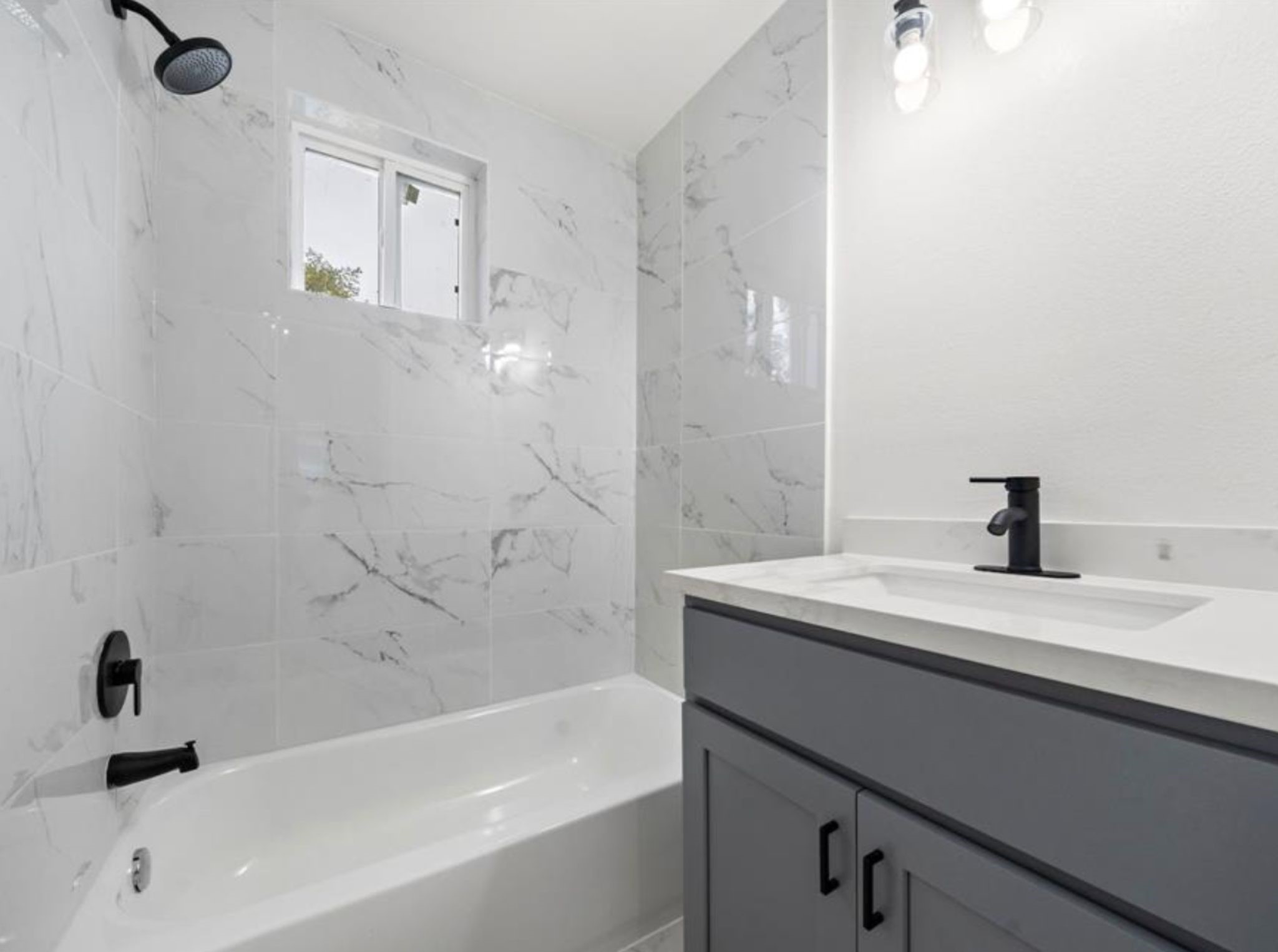 3524 Hadley Street Houston, TX 77004 - Photo 5 of 11 a bathroom with a sink a mirror and a bathtub