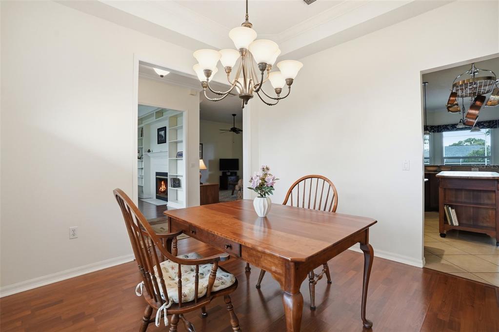 14228 Presteign Lane Spring Hill, FL 34609 - Photo 10 of 89 a view of a dining room with furniture and wooden floor