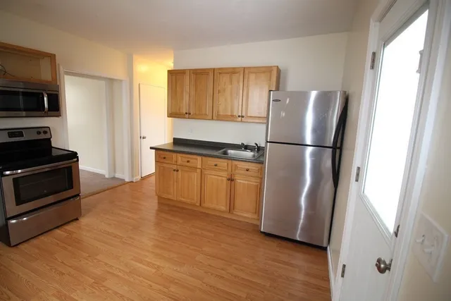 a kitchen with a refrigerator a stove top oven a sink and dishwasher
