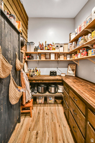 544 East 600 North, Unit 1 Joseph, UT 84739 - Photo 13 of 65 Expansive pantry featuring wood-finish flooring, custom wood cabinetry, extensive open shelving, and butcher block countertops