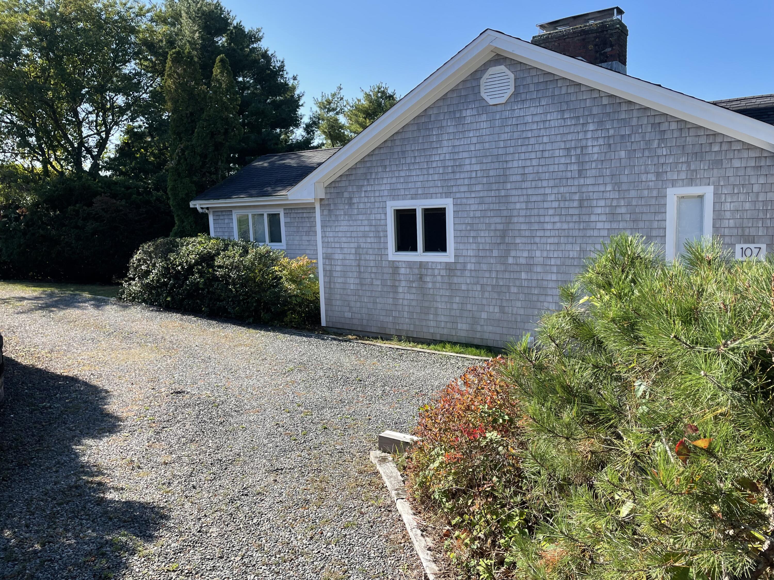 107 Abbey Gate Road Cotuit, MA 02635 - Photo 1 of 22 a front view of a house with a yard