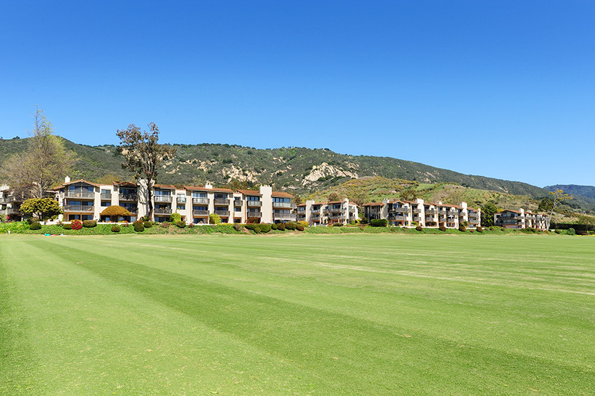 a view of an houses with outdoor space and mountain view