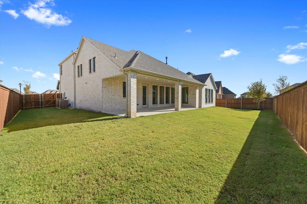 4626 Rillstone Road Midlothian, TX 76065 - Photo 36 of 40 Back of house with a patio area, a fenced backyard, brick siding, and roof with shingles