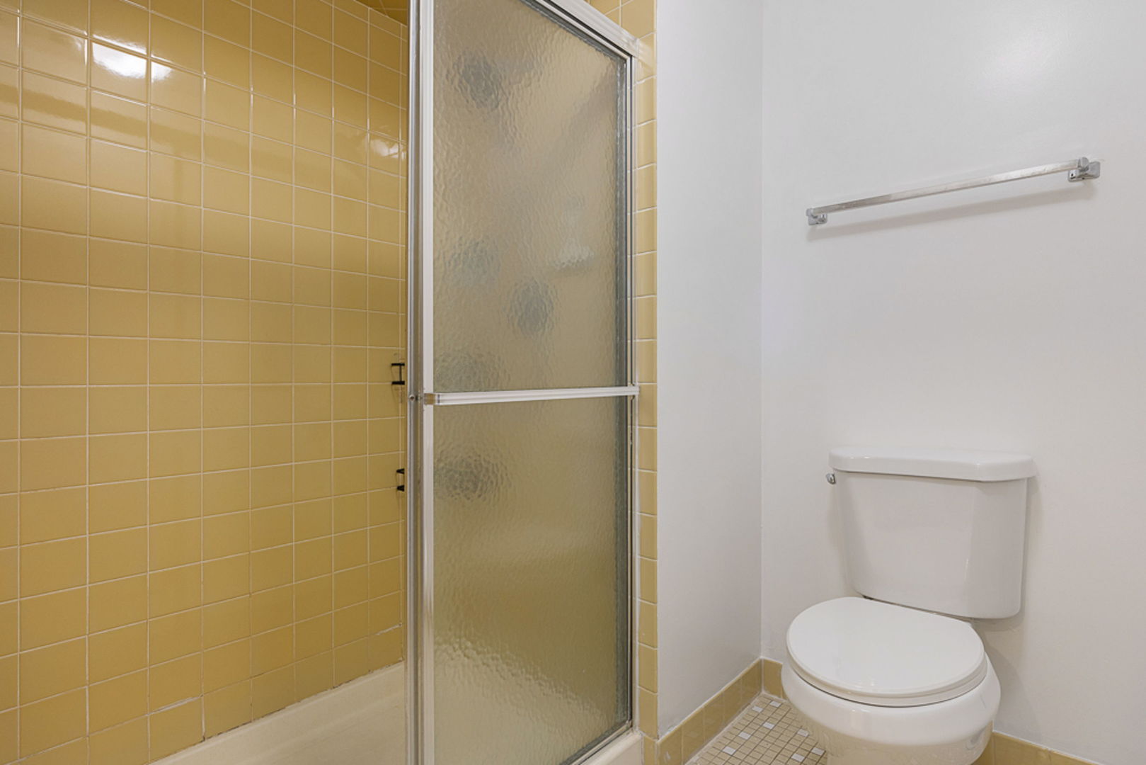 801 79th Street, Unit 103 Darien, IL 60561 - Photo 10 of 19 a white toilet sitting next to a bathroom sink