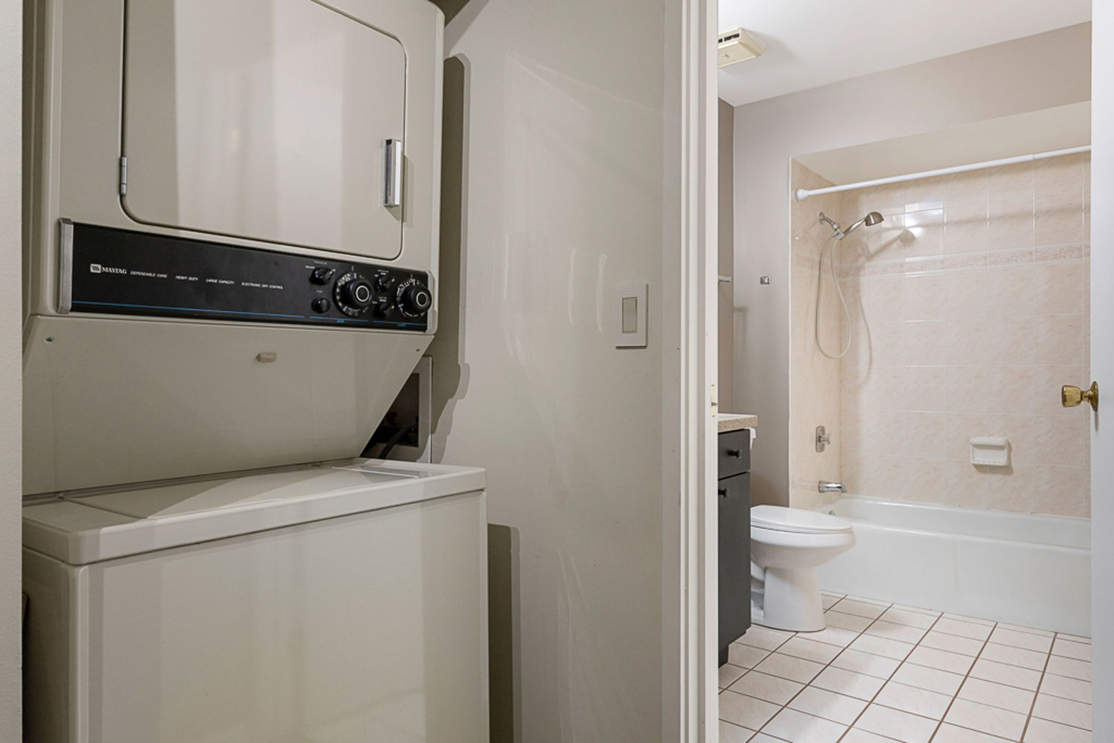 801 79th Street, Unit 103 Darien, IL 60561 - Photo 15 of 19 a view of bathroom with a toilet a sink and a mirror