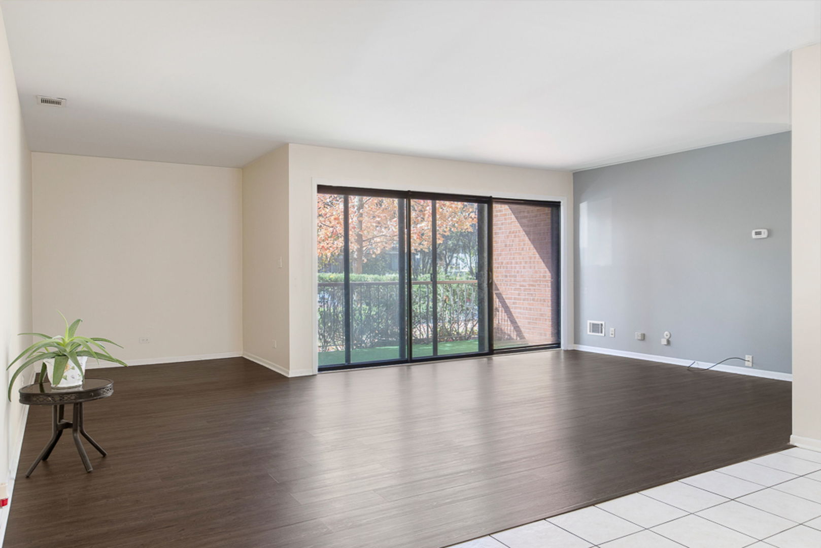801 79th Street, Unit 103 Darien, IL 60561 - Photo 2 of 19 a view of an empty room with wooden floor and a window