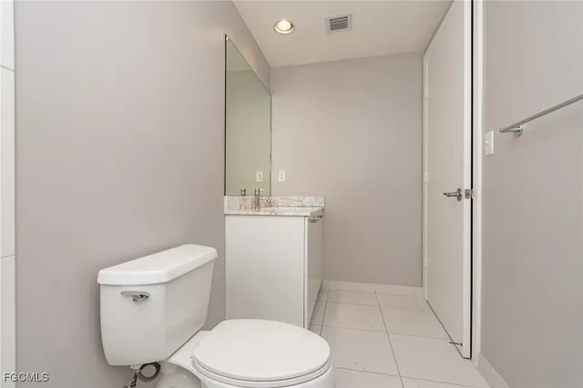a bathroom with a granite countertop sink and vanity
