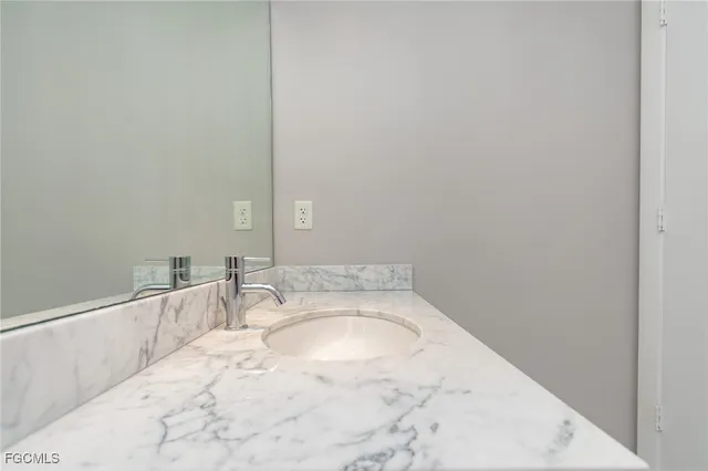 a kitchen with granite countertop a stove a sink and a microwave