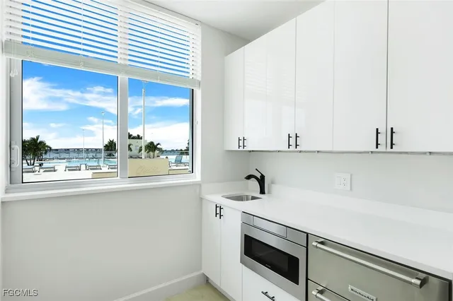 a view of a kitchen with a sink and cabinets