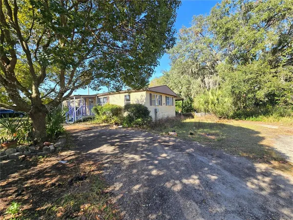 a view of an house with backyard space and garden