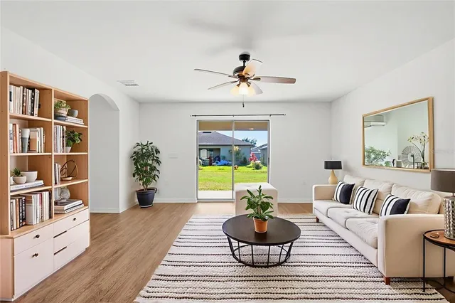 a living room with furniture and a potted plant