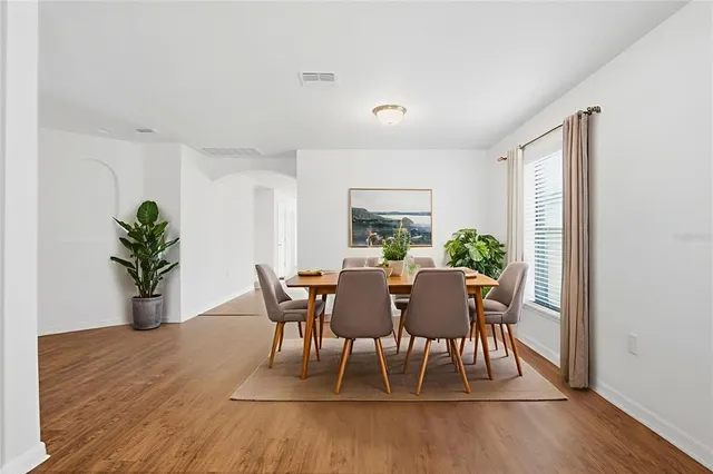 a view of a dining room with furniture and wooden floor