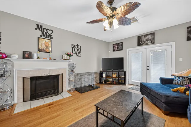 a living room with furniture a fireplace and a flat screen tv