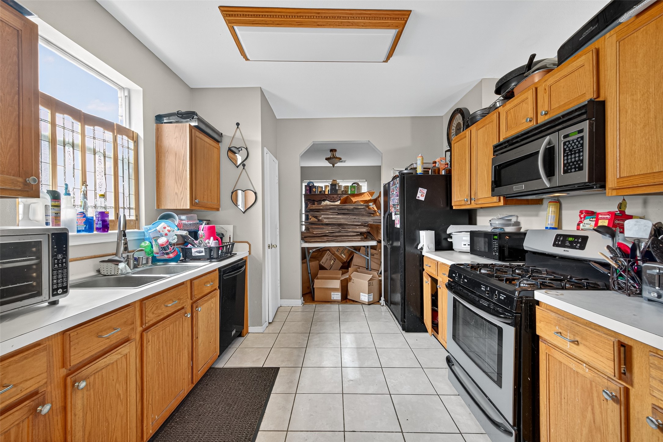 907 Morley Park Lane Spring, TX 77373 - Photo 19 of 44 a kitchen with stainless steel appliances granite countertop a stove a sink and a microwave