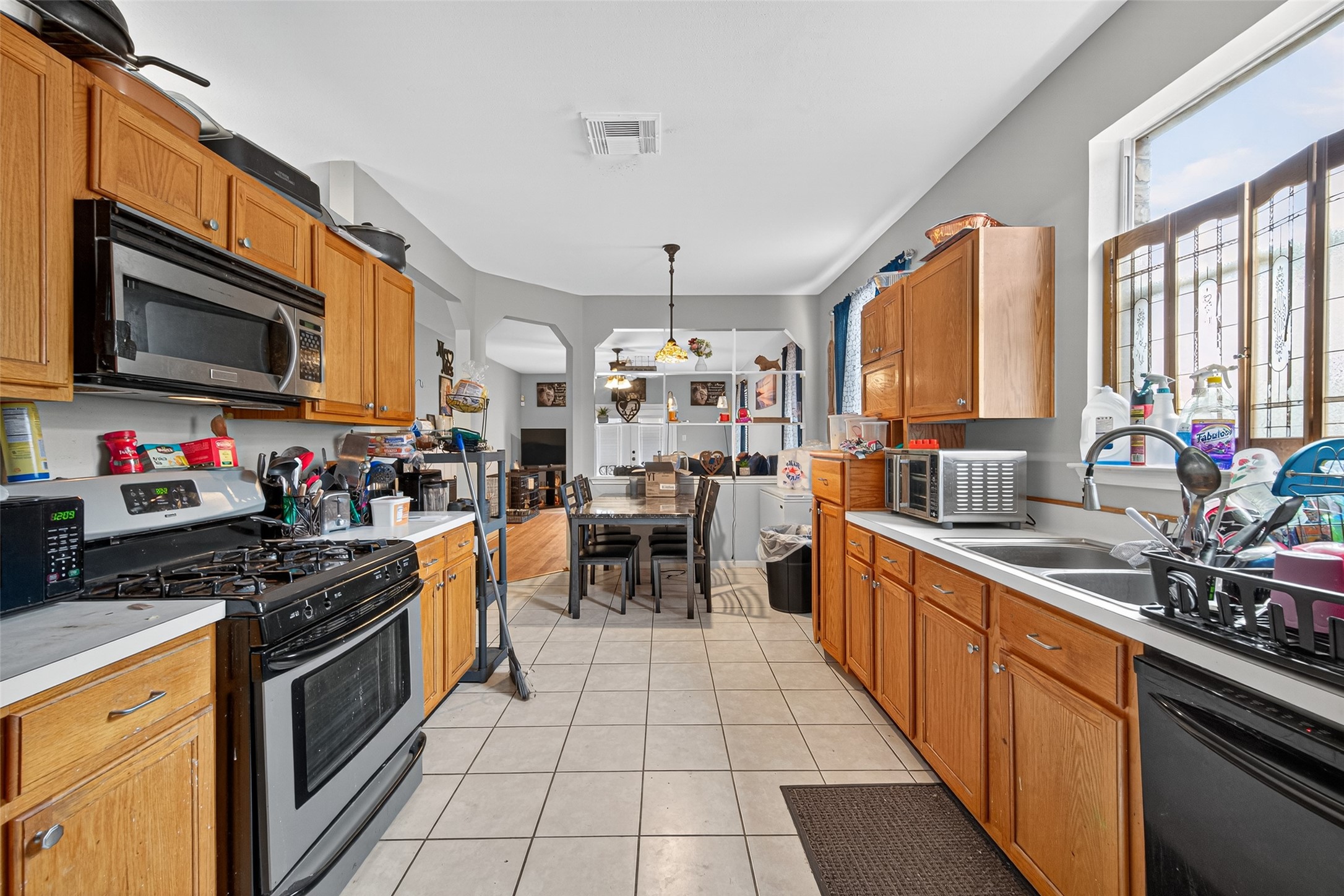 907 Morley Park Lane Spring, TX 77373 - Photo 25 of 44 a kitchen with stainless steel appliances a stove sink microwave and cabinets