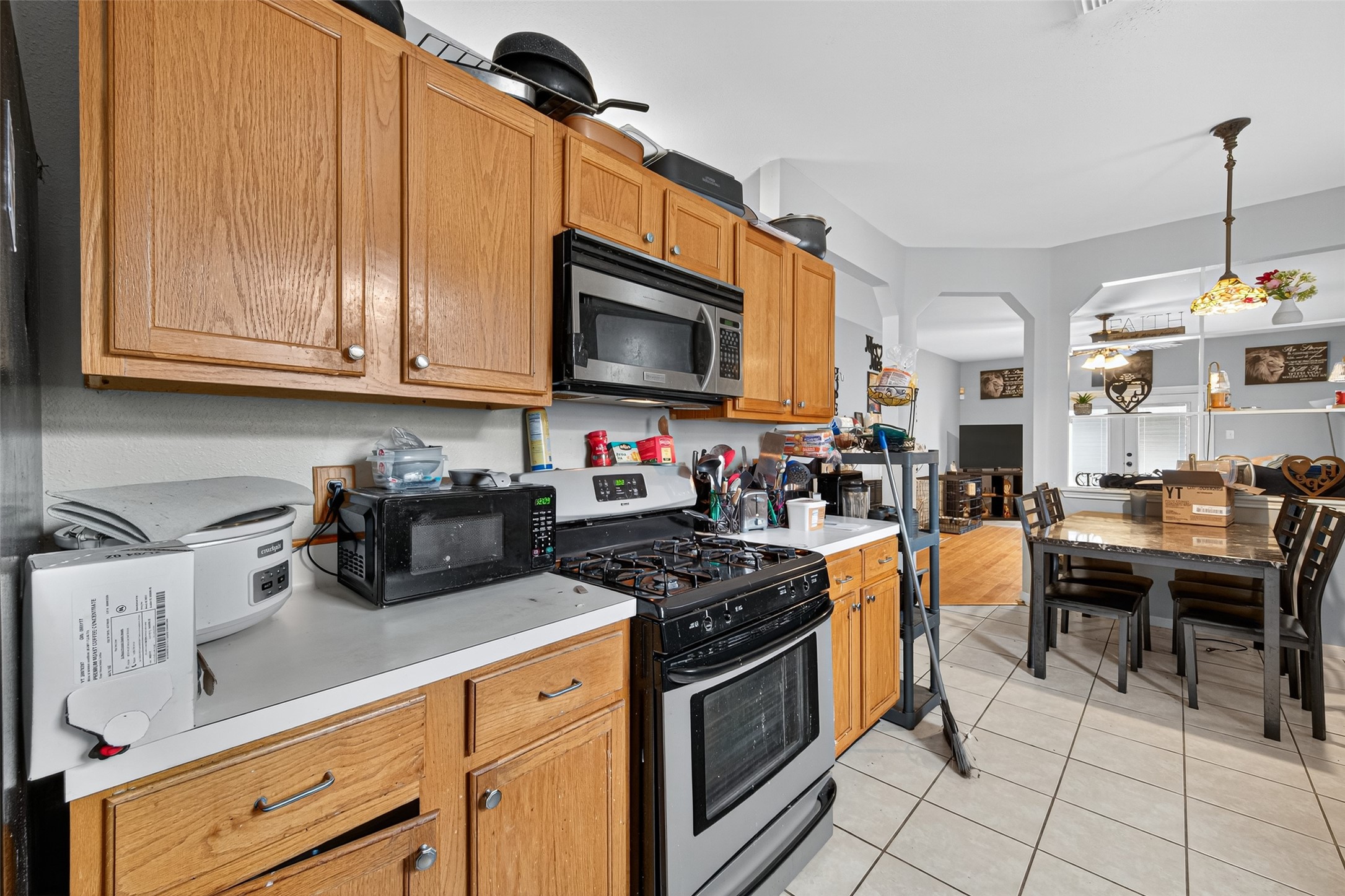 907 Morley Park Lane Spring, TX 77373 - Photo 26 of 44 a kitchen with granite countertop a stove a sink dishwasher and white cabinets with wooden floor