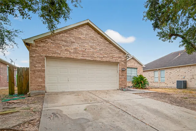 a view of a house with a yard and garage