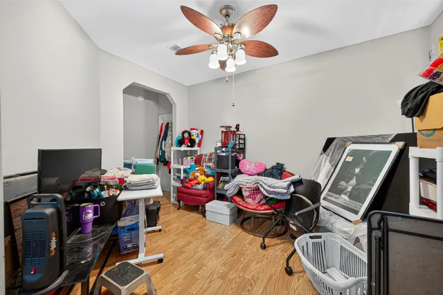 a bedroom with furniture a small book shelf and a window