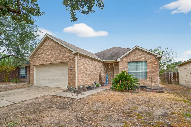 a view of a house with a yard and potted plants